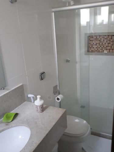 a bathroom with a toilet and a sink and a shower at Casa Paraíso dos Lagos in Camacari