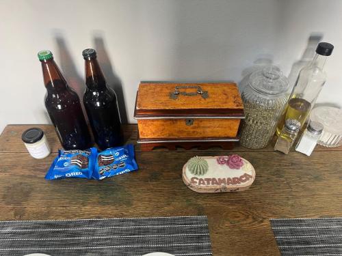 a wooden table with bottles and a chest on it at Quincho cervecero in San Fernando del Valle de Catamarca