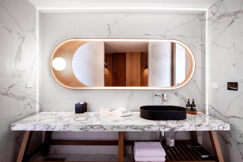 a bathroom with a sink and a mirror at Crowne Plaza Hobart by IHG in Hobart