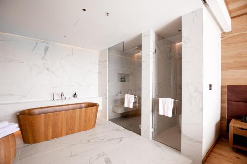 a bathroom with a tub and a shower at Crowne Plaza Hobart by IHG in Hobart