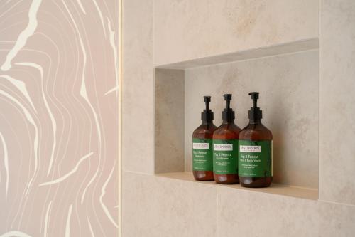 three bottles of wine sitting on a shelf in a wall at Crowne Plaza Hobart by IHG in Hobart