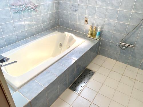 a bath tub in a bathroom with a drain at JOY GARDEN in Taku