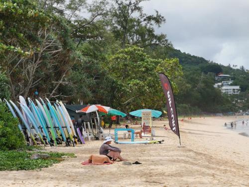 a group of people on a beach with surfboards at 6 Floor - Studio room at OZC near Kata beach in Kata Beach
