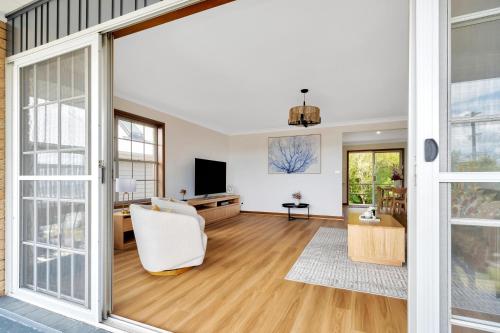 an open living room with a sliding glass door at Bateau Bay in Bateau Bay