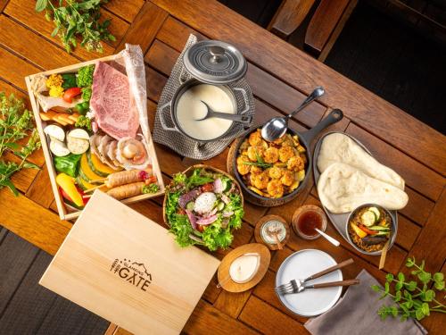 a wooden table topped with different types of food at GLAMPING GATE 奈良 in Nara