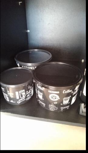 three pots sitting on a shelf in a kitchen at Chalé vista linda DM pedra azul in Domingos Martins