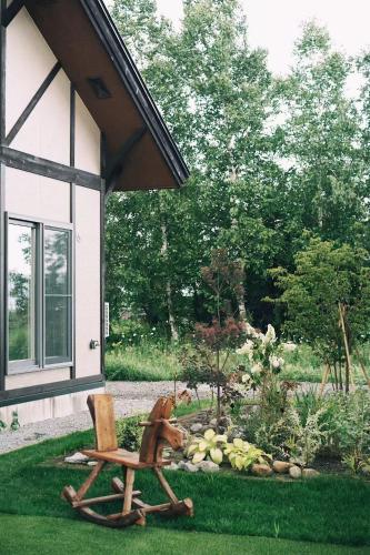 a chair and a chair sitting in a yard at Furano Cozy Whole House for 6 - Near lavender farm and Ski Resort - free parking in Nakafurano
