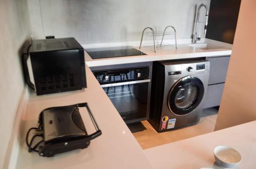 a kitchen with a laptop and a washing machine at Beach Loft next to the Sheraton Leblon in Rio de Janeiro