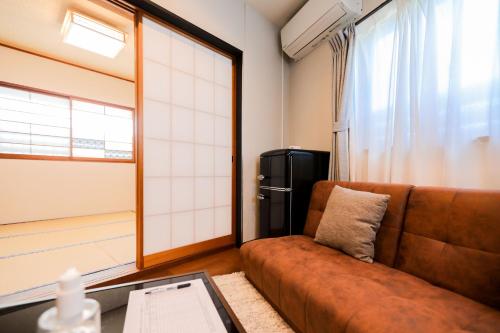 a living room with a couch and a refrigerator at 湯乃荘 in Hakone