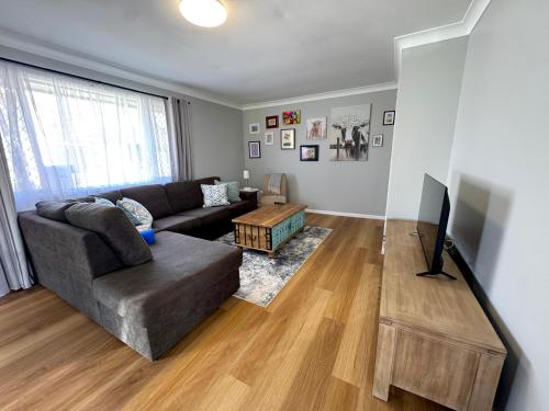 a living room with a couch and a table at The Gem on Britannia in Stanthorpe