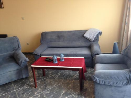 a living room with a couch and a red table at Daja Ház in Hévíz
