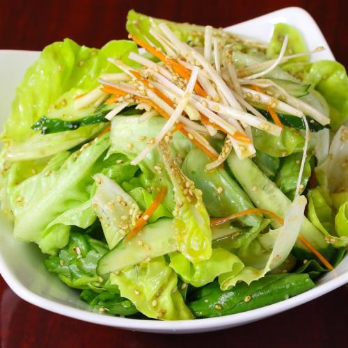 a white plate of salad with lettuce and vegetables at beppu turu 鶴 in Beppu