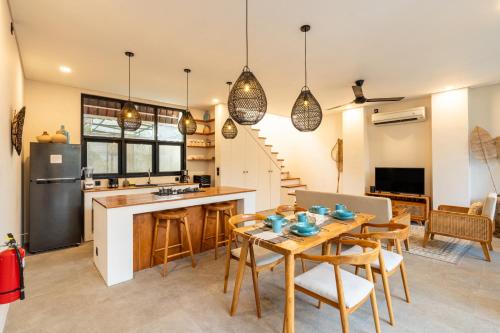 a kitchen and living room with a table and chairs at Hati Villa by Betterplace in Canggu