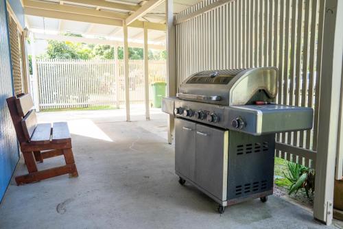a grill in a patio with a chair and a table at Great Escape at Amity in Amity Point