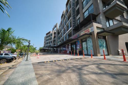 a street with orange cones in front of a building at The Diamond In City Luxury Suites By ZENORA Living in Accra