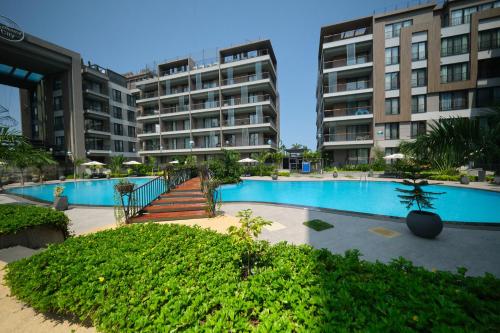 a resort with a swimming pool and some buildings at The Diamond In City Luxury Suites By ZENORA Living in Accra