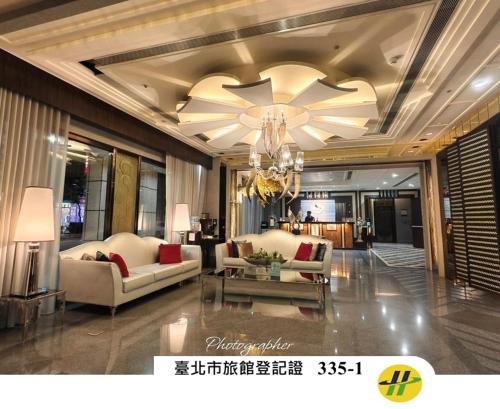 a living room with two couches and a chandelier at XINSHE Hotel - Linsen in Taipei