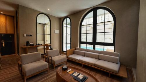 a living room with a couch and two chairs at Hygge Hotel and Villas Seminyak in Seminyak
