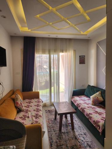 a living room with a couch and a table at بورتو مطروح ألهاني families only in Marsa Matruh