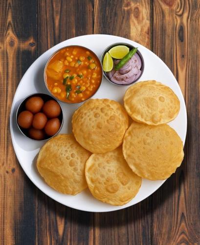 a plate of food with biscuits and eggs on a table at Al Hayat Guest House in Pahalgām