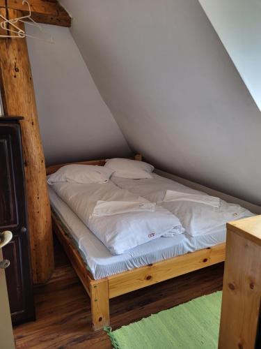 a bedroom with a bed in a attic at Pension Cabana Cetatile Ponorului in Padis
