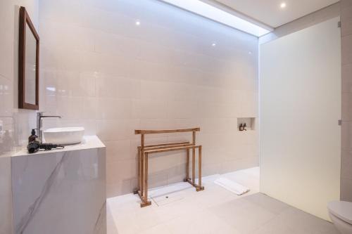 a bathroom with a sink and a toilet at 2 Bedrooms Private Pool Villa Cemagi in Cemagi