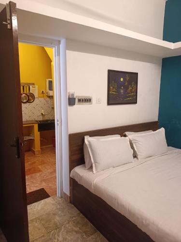 a bedroom with a bed with white pillows at Villa Betty Individual 2 Rooms property at beach front Near French colony in Pondicherry