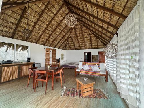 a living room with a table and a dining room at Papapa grecas in Zipolite