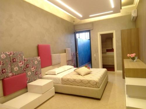 a bedroom with a bed and a couch in it at Luxury B&B Coccolhouse in San Cesario di Lecce