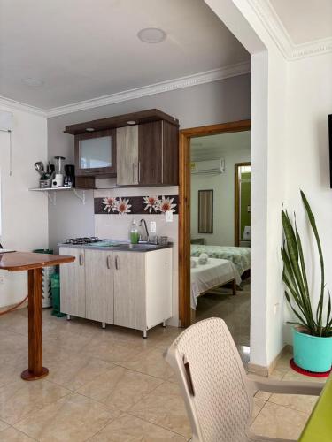 a kitchen with a sink and a table in a room at Janeth’s Place Apartamento in San Andrés