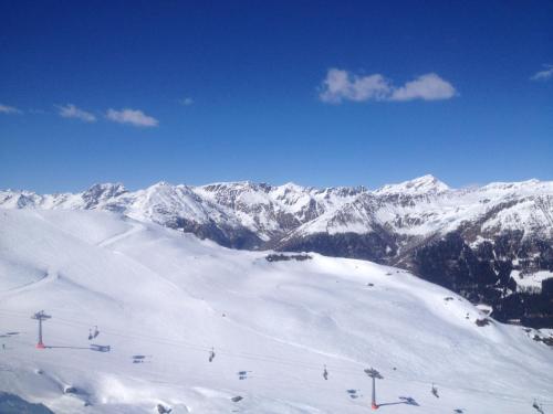 a snow covered mountain with a ski lift on it at Refugium Dolomiten & Chalet in Sillian