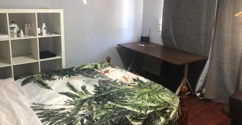 a bedroom with a desk and a bed and a table at Airport Master Room in Perth