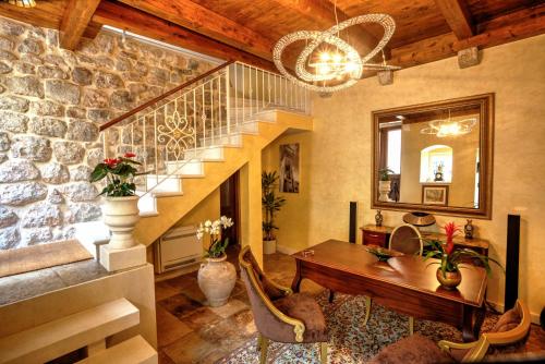 a living room with a staircase and a table at Dominus Little Palace in Dubrovnik