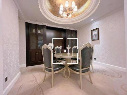 a dining room with a table and chairs at Tongxiang Inspirock Hotel in Jiaxing