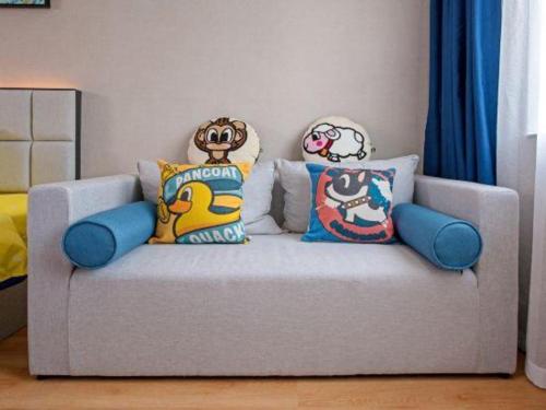 a couch with pillows on it in a living room at danfeng kelly hotel in Shenzhen