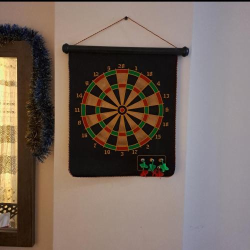 a dart board hanging on a wall at Tiba Golden Beach Resort, Down Town in Hurghada