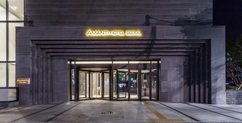 an entrance to a building with a sign on it at Amanti Hotel Seoul Hongdae in Seoul