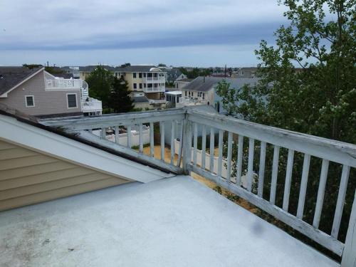 a balcony with a white railing on a house at Oceanside, Single Family, Private Yard, Wifi, Washer Dryer, Ocean Side Home In Beach Haven 60092, in North Beach Haven