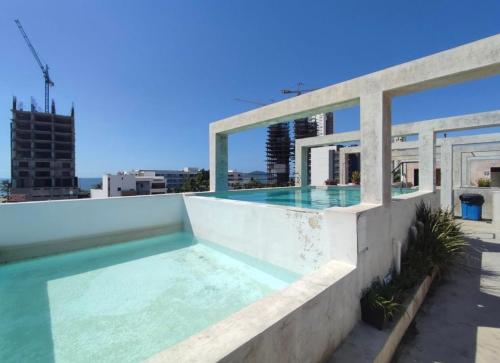 a swimming pool on the roof of a building at Departamento en Mazatlán in Mazatlán