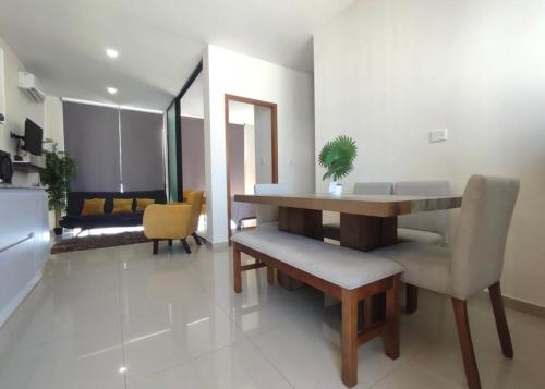 a living room with a dining room table and chairs at Departamento en Mazatlán in Mazatlán