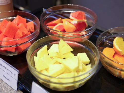 four bowls of fruits and vegetables on a table at Dormy Inn Tokyo Hatchobori - Natural Hot Spring in Tokyo