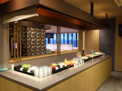 a buffet line in a restaurant with food at Dormy Inn Tokyo Hatchobori - Natural Hot Spring in Tokyo