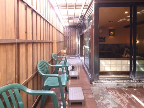 a row of green chairs sitting inside of a restaurant at Dormy Inn Tokyo Hatchobori - Natural Hot Spring in Tokyo