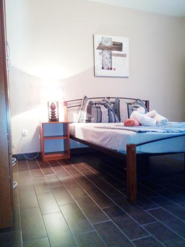 a bedroom with two beds and a lamp on a floor at Holiday Home Turalija in Vodice