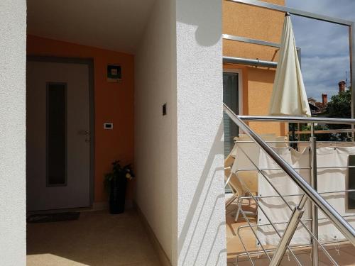 a balcony of a building with a staircase and a door at Apartment Lency in Novigrad Istria