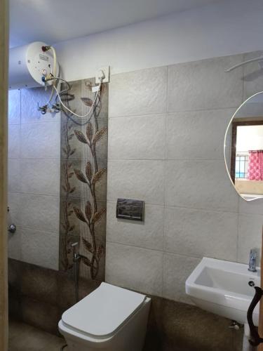 a bathroom with a toilet and a sink at Valley View in Kodaikānāl