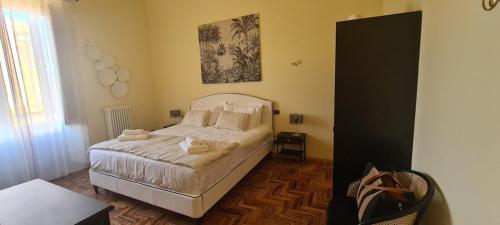 a bedroom with a bed with towels on it at Luxury Sea Palazzo in Trani