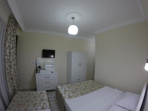 a small bedroom with two beds and a mirror at Pınar Vintage House in Pamukkale