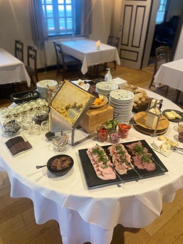 a white table with many different types of food on it at Filskov Kro in Grindsted
