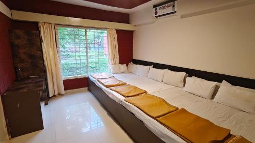 a room with a large bed with a window at Golden Hill Resort in Chikmagalūr